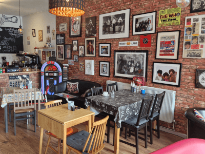 Inside the Coffee Stop in Leigh with lots of photo's in black frames on the wall with music memorabilia