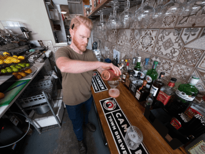One of the owners of Hideout in Wigan making a cocktail behind the bar