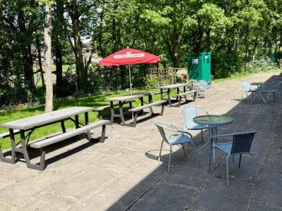 picnic tables and chairs on the patio of a building