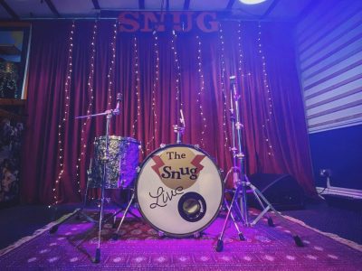 A drumkit setup on the stage at the Snug Coffee house in Atherton